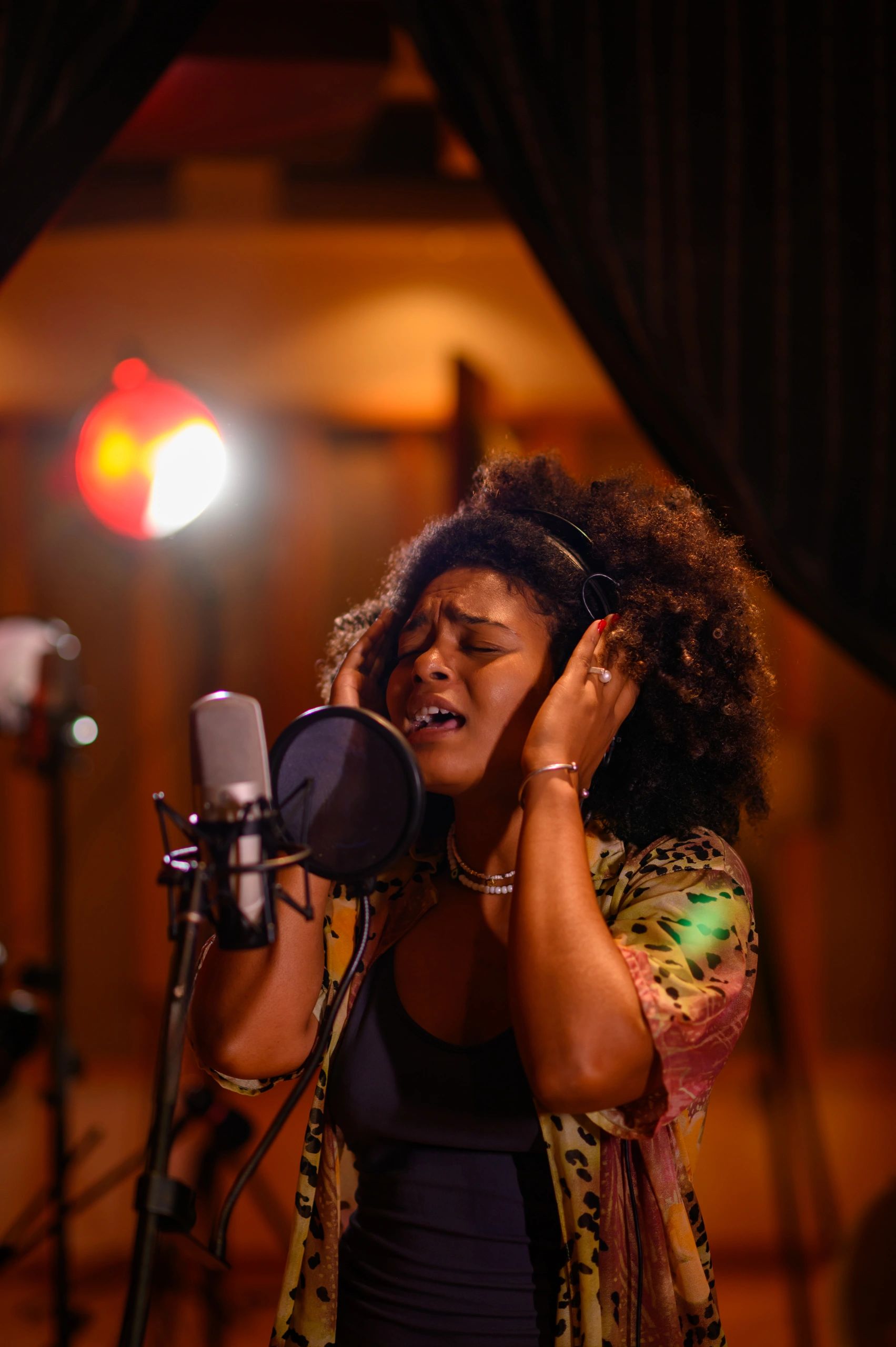 Podcast guest speaking into a microphone in studio